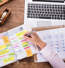 Desk covered with planning and scheduling materials