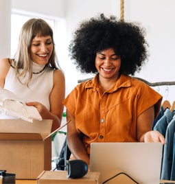 Two women packing up an order for an online store