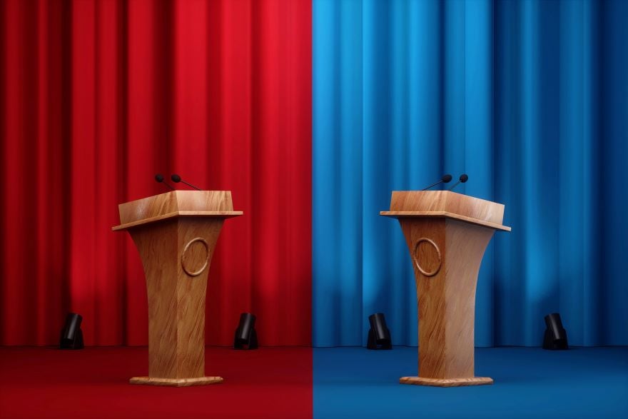 Photo of a red and blue curtain with a podium on each side