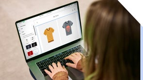 Person using an online store builder on her laptop to customize her t-shirt products on her ecommerce store