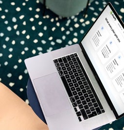 Overhead view of a laptop in use with Shopify plan information on-screen