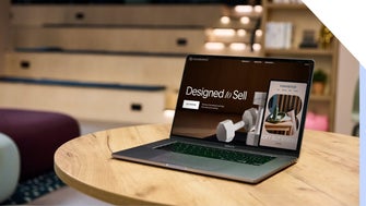 A laptop sitting open on a table in an office, with a Squarespace page open on-screen with the text 